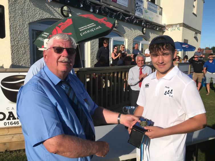 Trefor Evans of the Pembroke County Cricket Club presents a medal to Owen Phelps